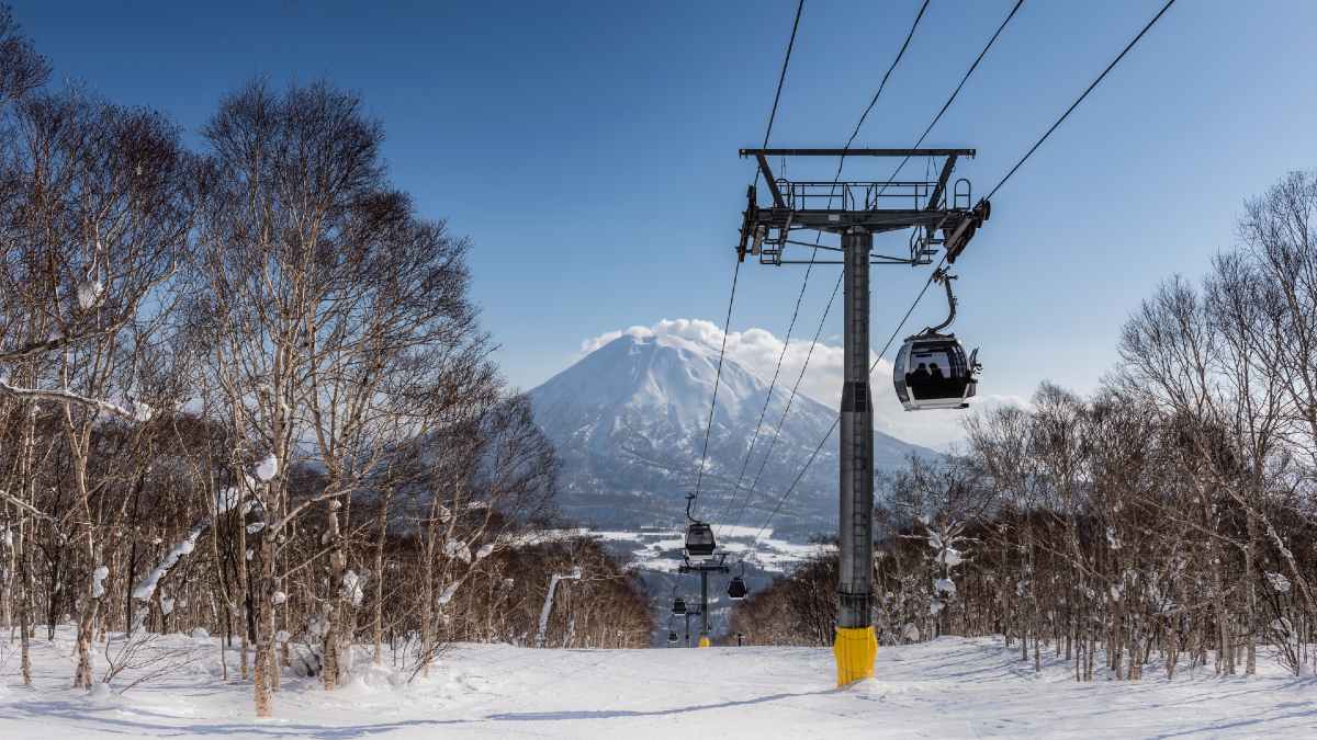 People skiing in the distance on a snow field