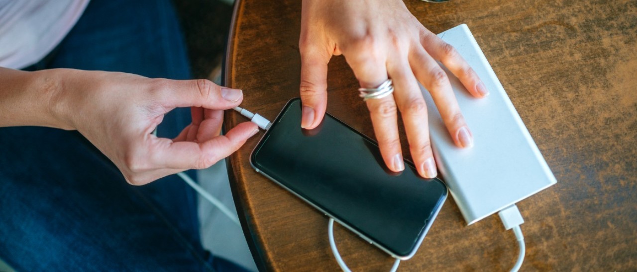 woman charging her smartphone with a powerbank