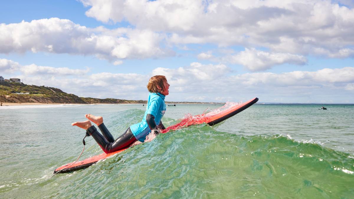 boy surfing in ocean