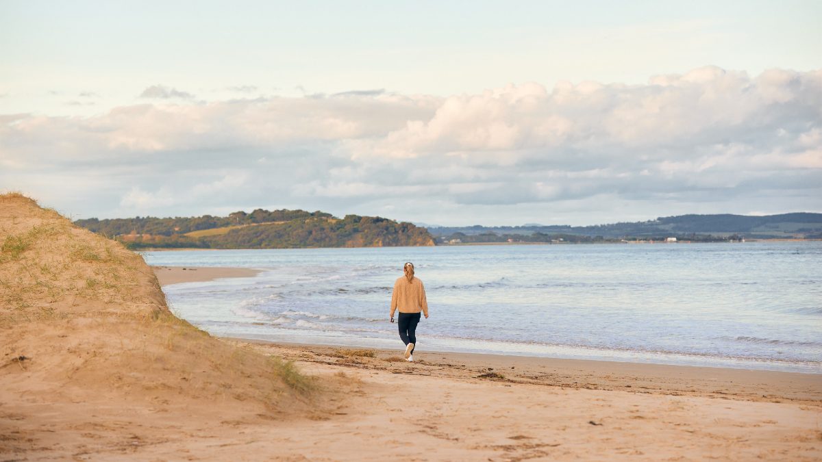 woman walking along a beach
