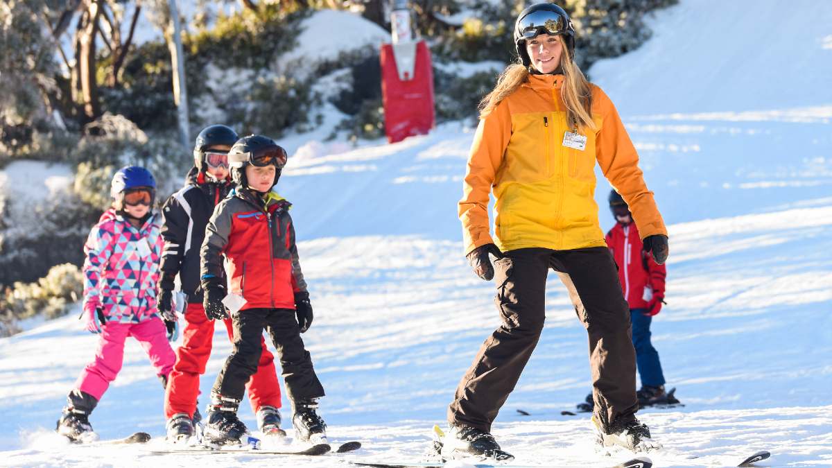 adult leading four children in a ski lesson at Mt Baw Baw, Victoria