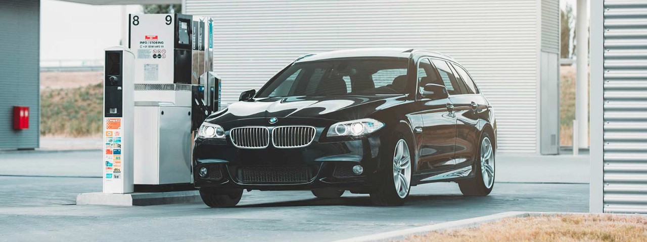 Black car without number plates parked at petrol station