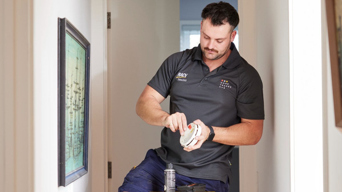 RACV electrician checking smoke alarm