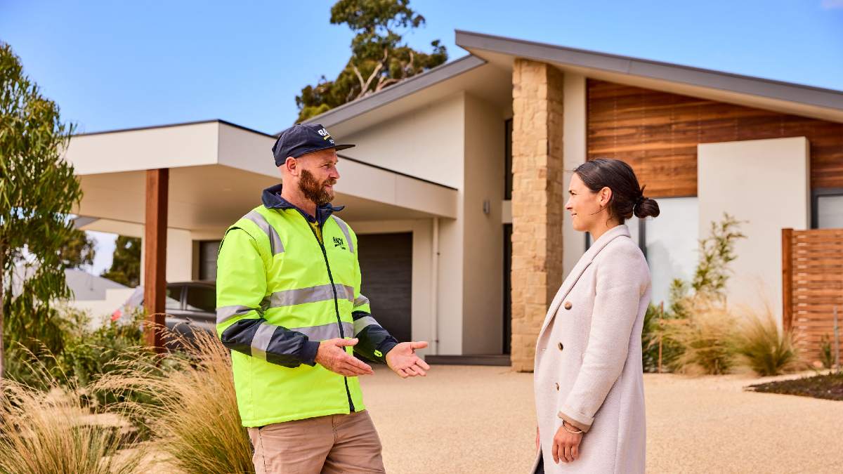 RACV Solar technician talking to homeowner outside her house