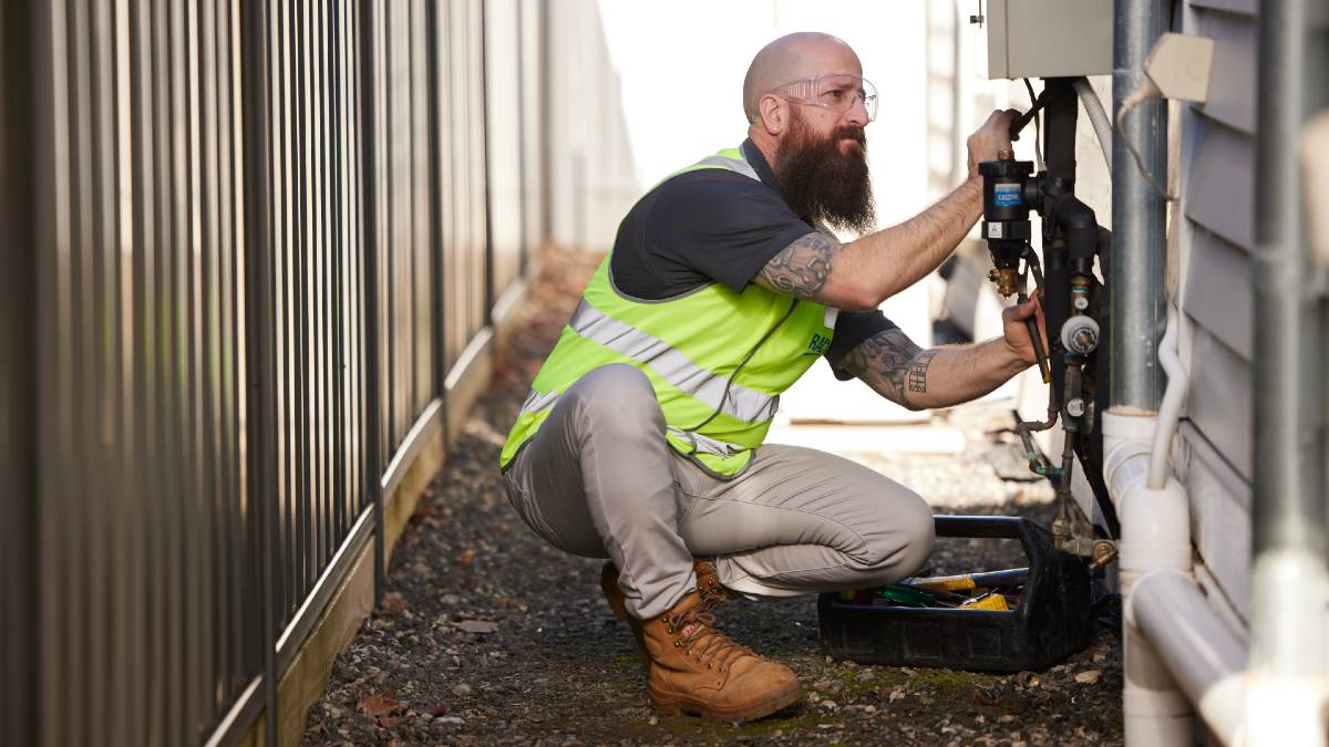 RACV plumber fixing hot water system