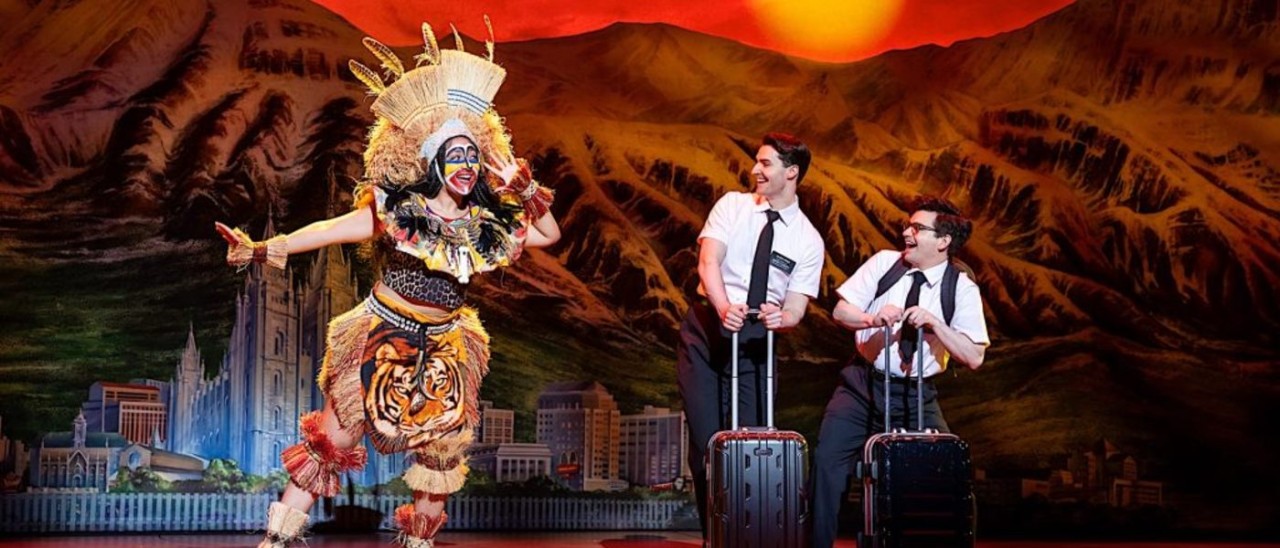three actors on stage in Sydney's production of The Book of Mormon
