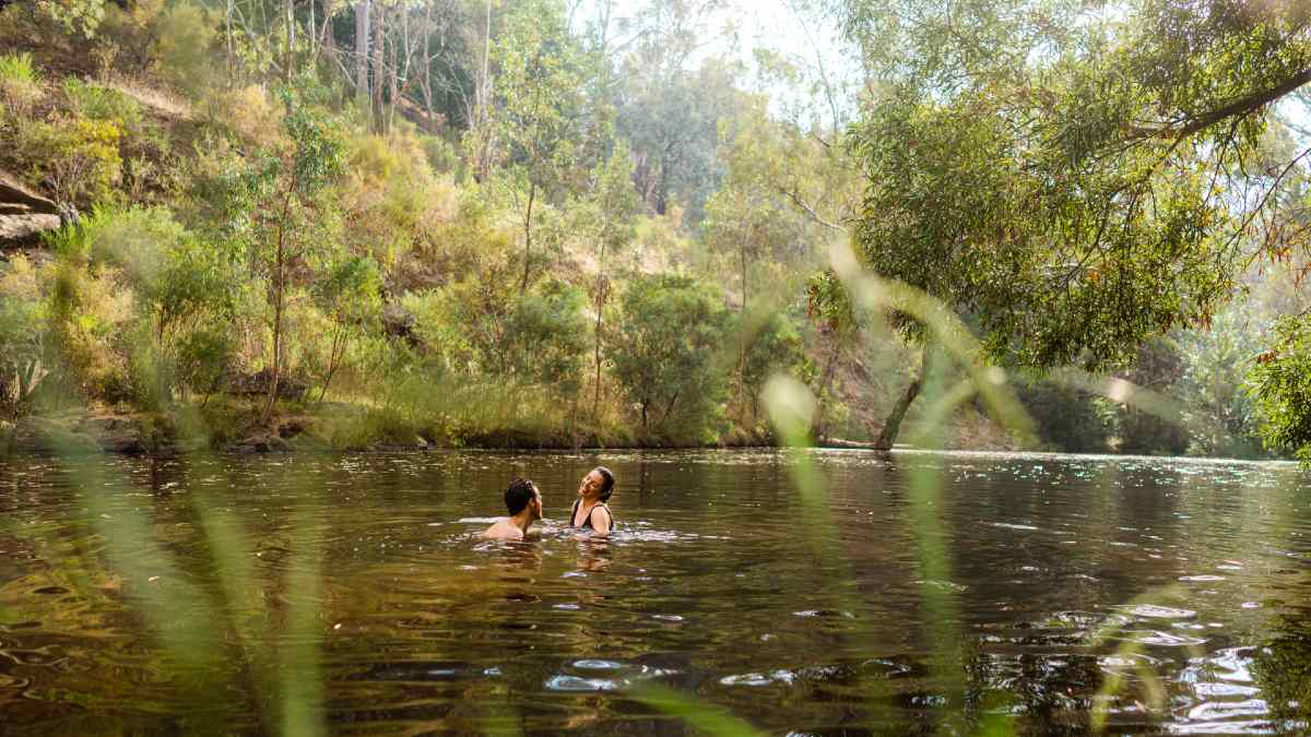 couple swimming in creek