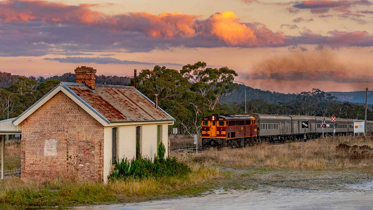 Vintage train pulling into historic station in NSW.