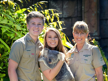 Terri, Bindi and Robert Irwin posing with a koala at Australia Zoo.