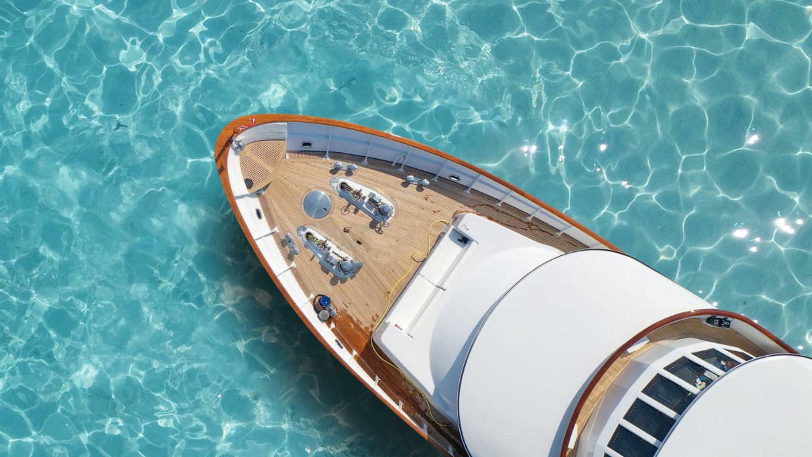 Tip of boat on clear blue water