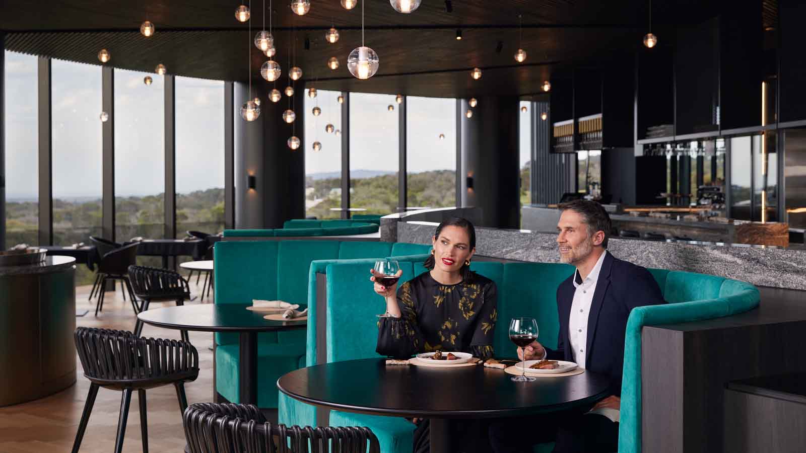A couple enjoying dinner at Cape Schanck's Cape restaurant.