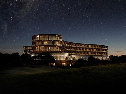 RACV Cape Schanck Resort building exterior at night with star filled sky.