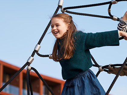 Child playing on playground ropes at RACV Cape Schanck Resort.
