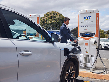Person charging their electric vehicle, at a Chargefox station.