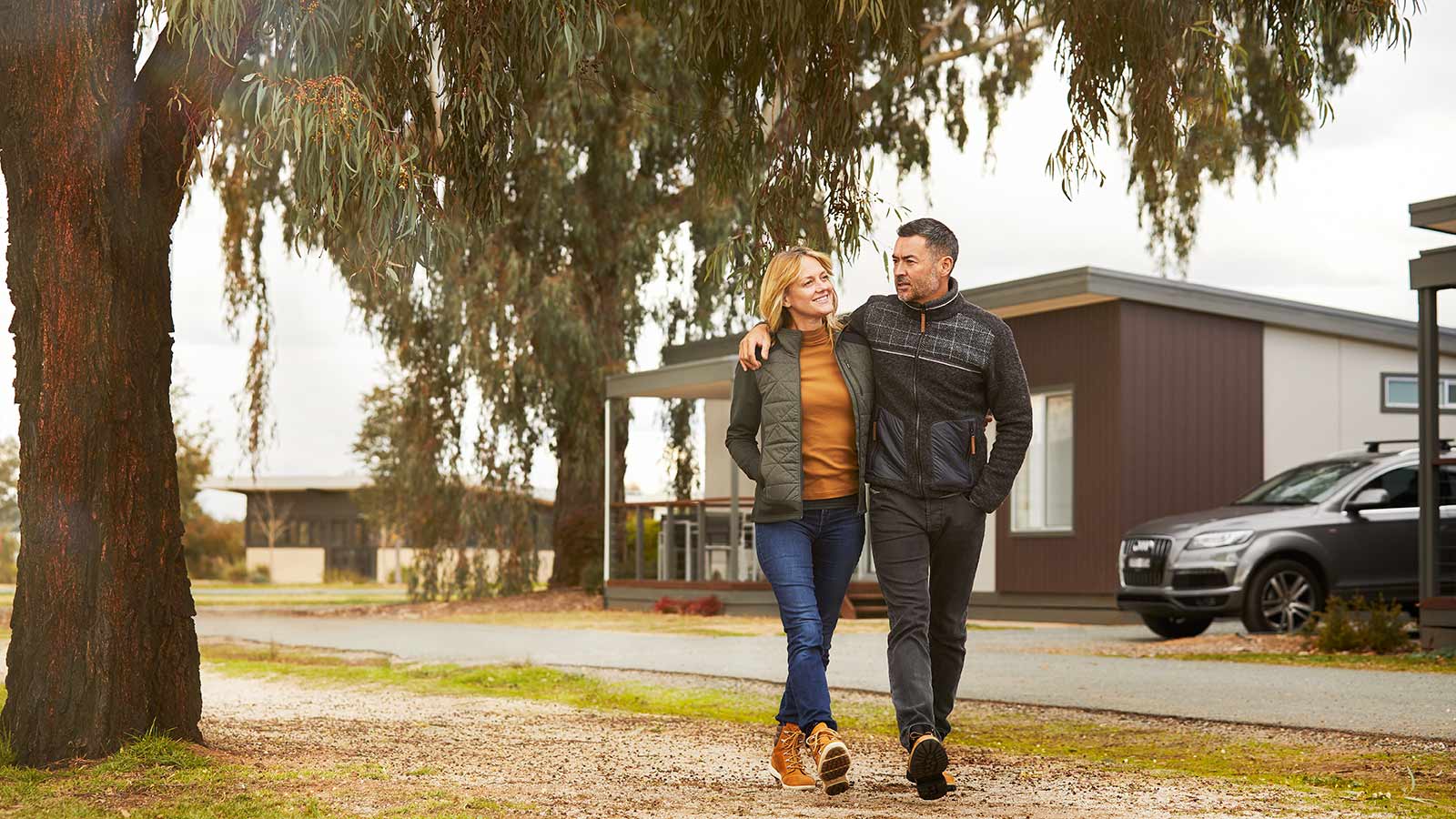 Couple walking by accommodation at RACV Cobram Resort.
