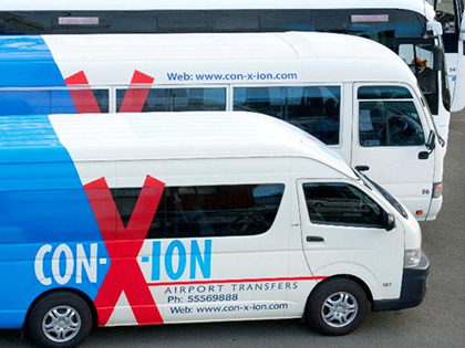 Con-X-Ion shuttle buses parked in a row.