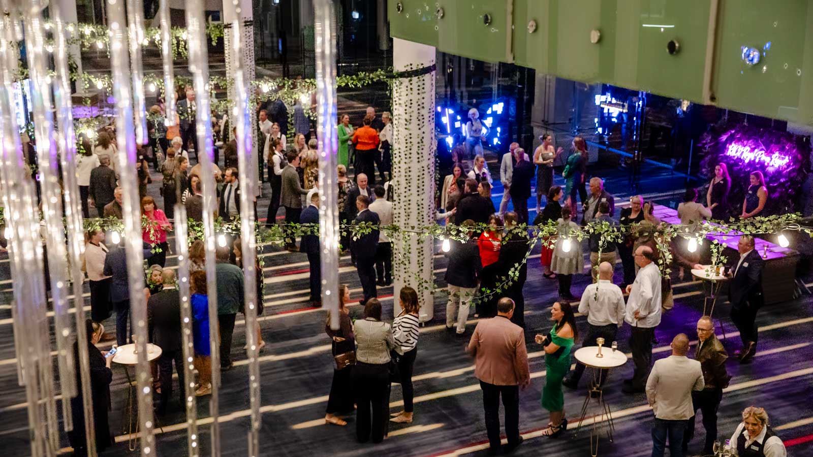 An event at Royal Pines heavily decorated with guests mingling. 