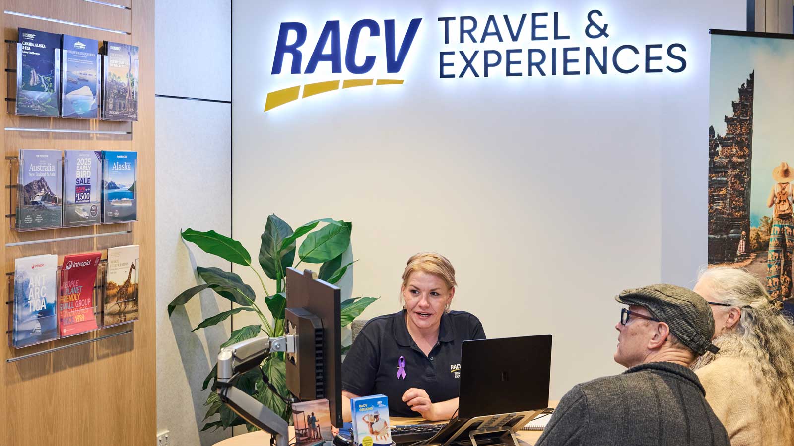 RACV Geelong travel agency with agent helping a customer at the desk. 