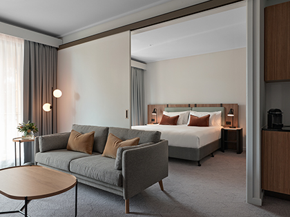 Two-bedroom room at RACV Goldfields Resort, featuring a queen bed, couch and coffee table.
