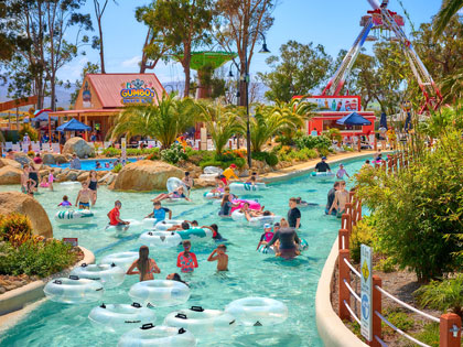 Multiple people swimming in the water river at Gumbaya world. 