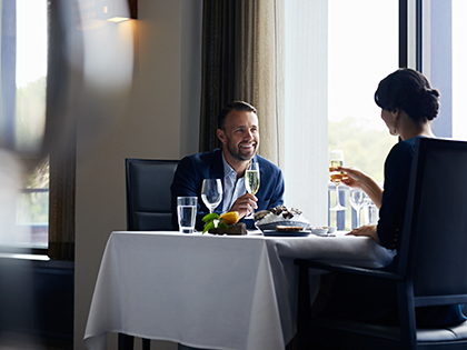 A couple sitting together at a restaurant at RACV Healesville Country Club and Resort.
