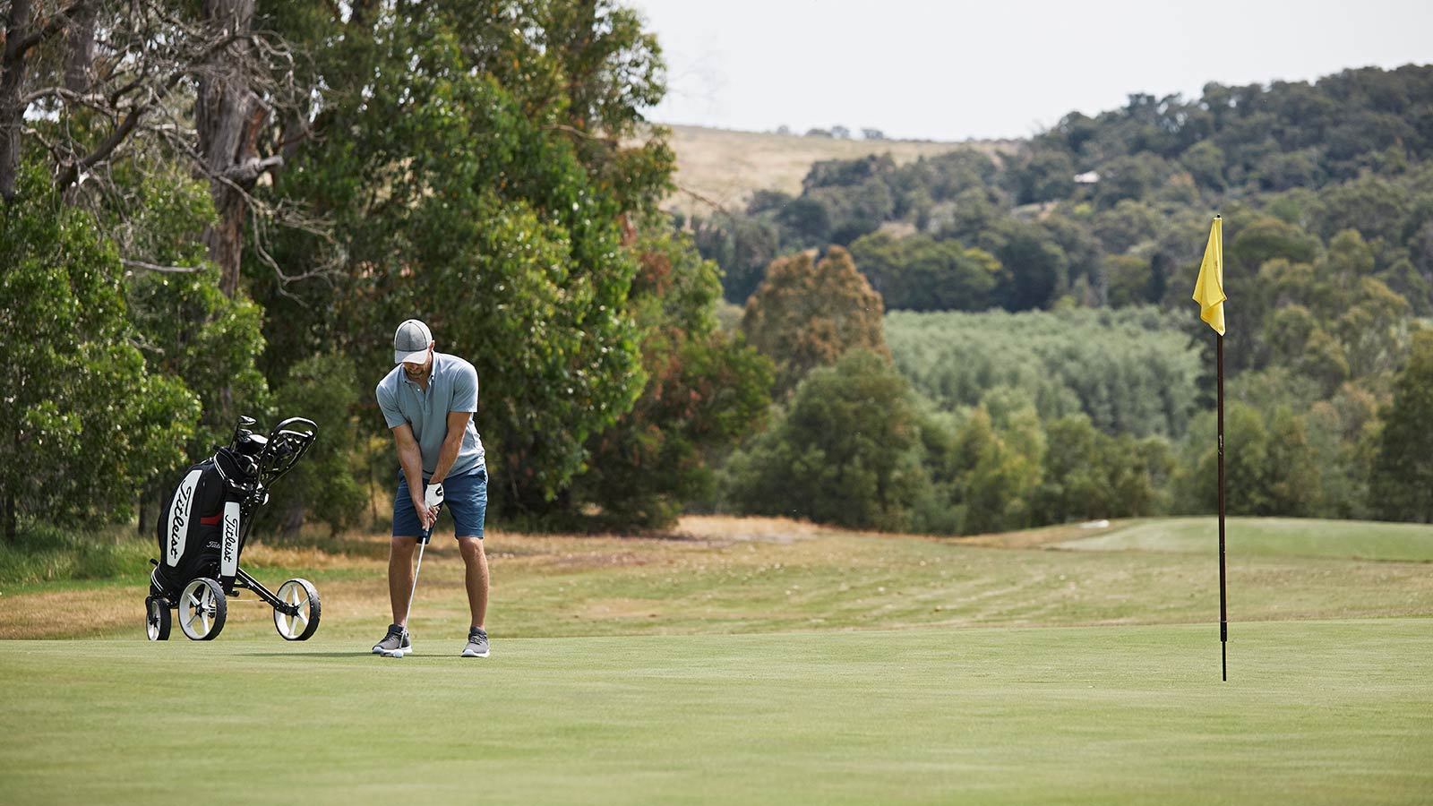 Person playing golf at the 18-hole golf course at RACV Healesville Country Club and Resort.