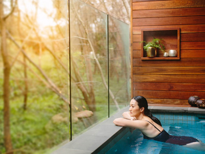 Woman looking out the window of a pool in Hepburn Springs