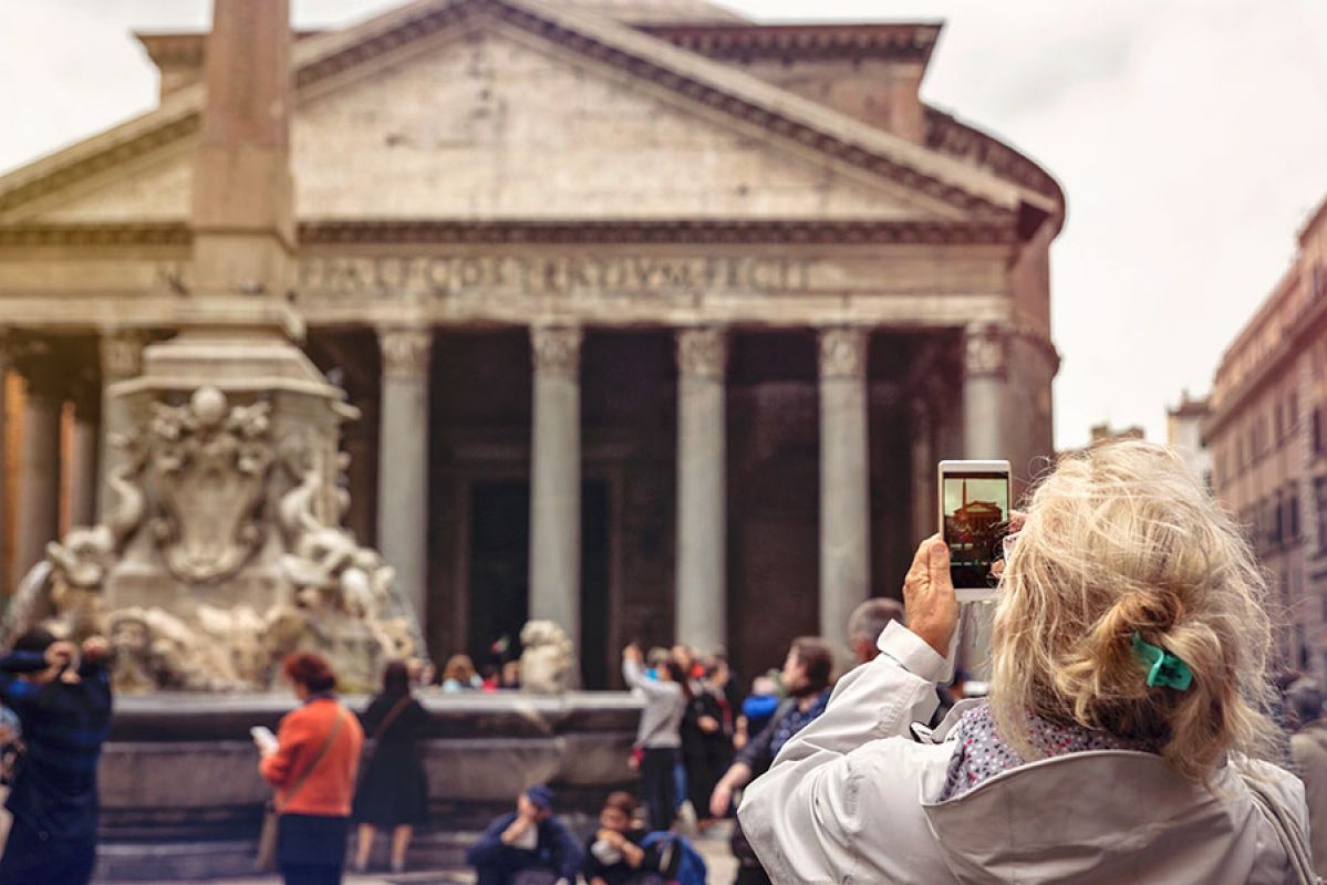 woman leaning on surfboard, man snorkeling below 