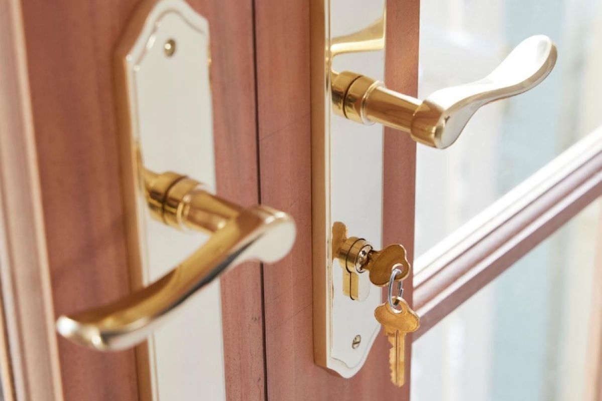 A golden door lock with a key in it
