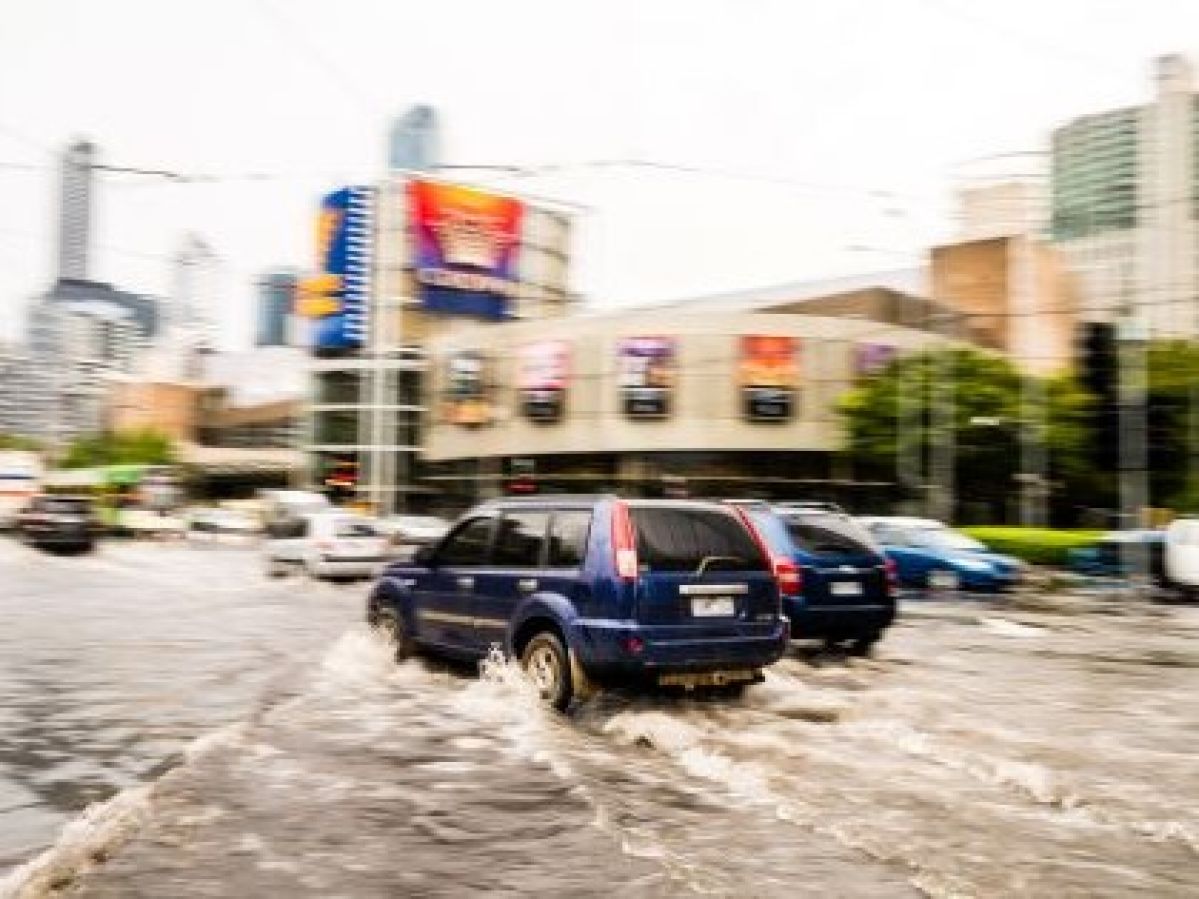 Cars driving through flood waters.