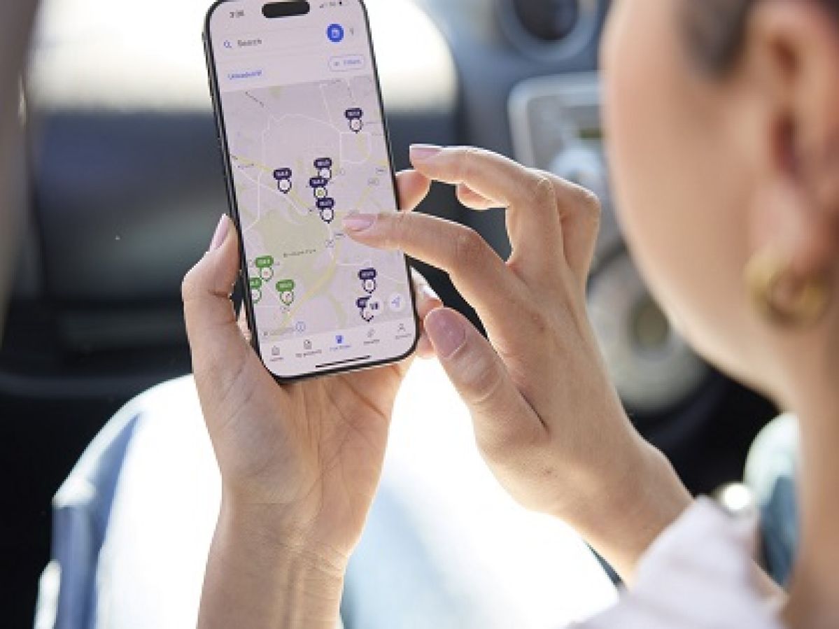 Woman looking at the petrol prices on the RACV app