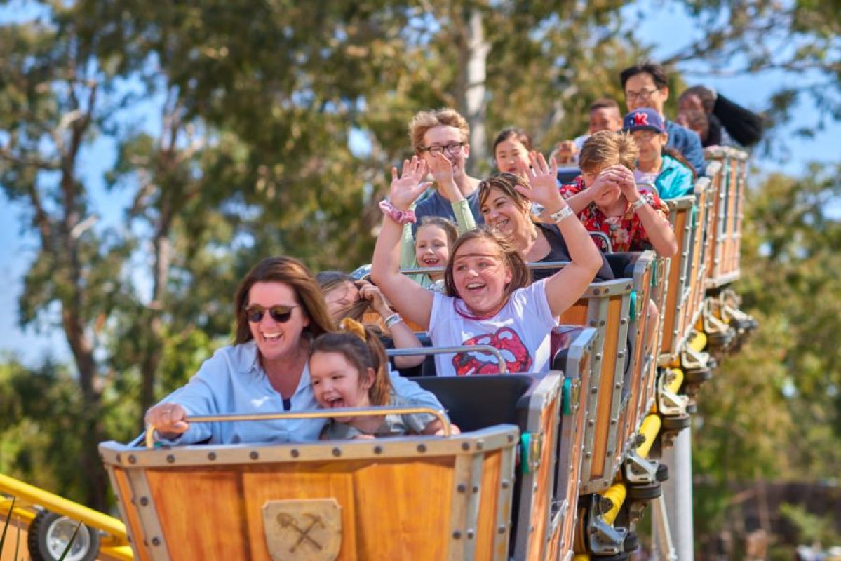 people riding a family rollercoaster