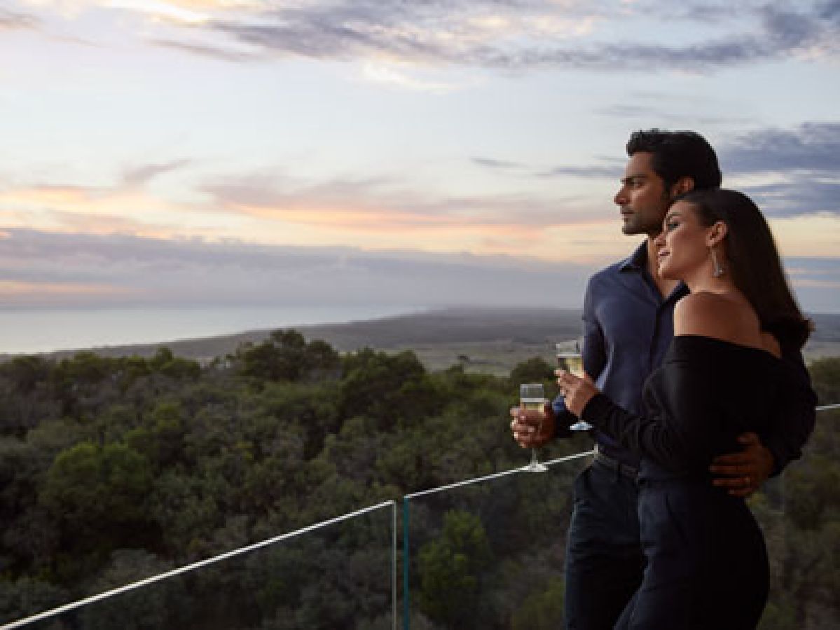 Couple enjoying the view from their room's balcony at Cape Schanck.