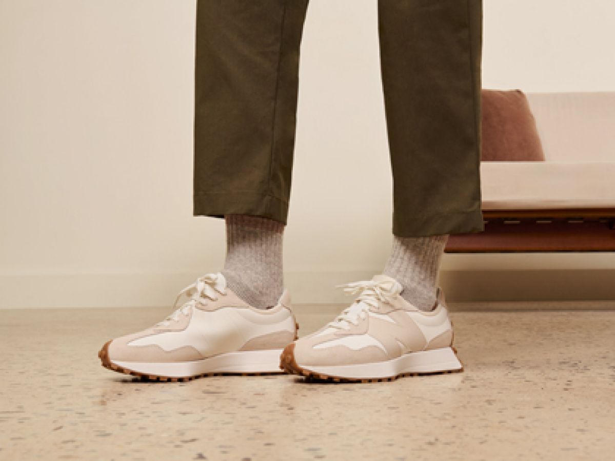 A pair of legs with New Balance sneakers. 
