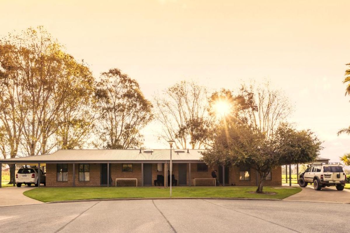 exterior shot of brick home with two cars