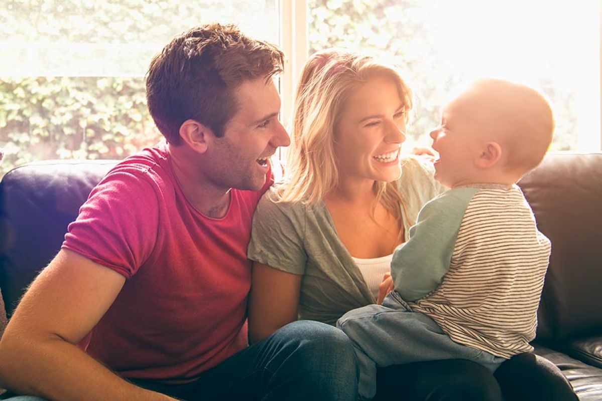 young woman on phone and laptop with papers