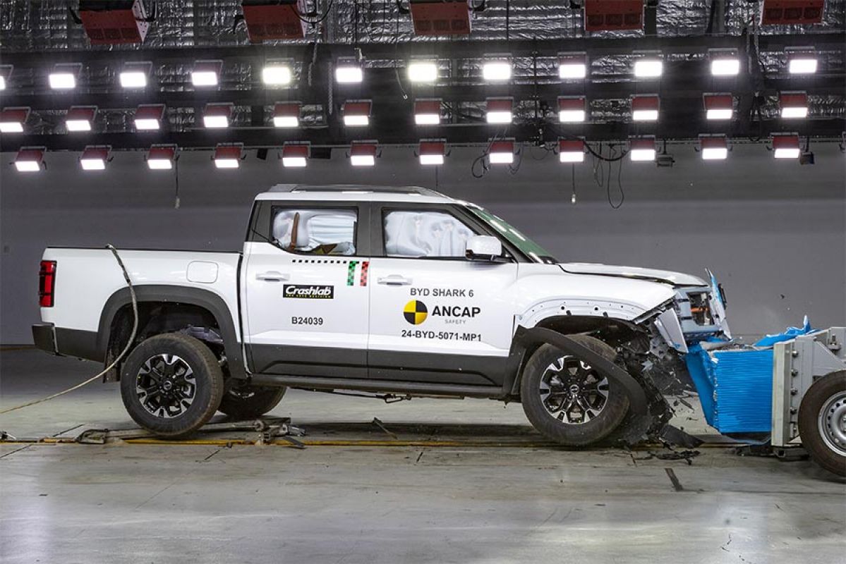 White BYD Shark 6 ute with damaged front end after crashing into deformable barrier for ANCAP testing.