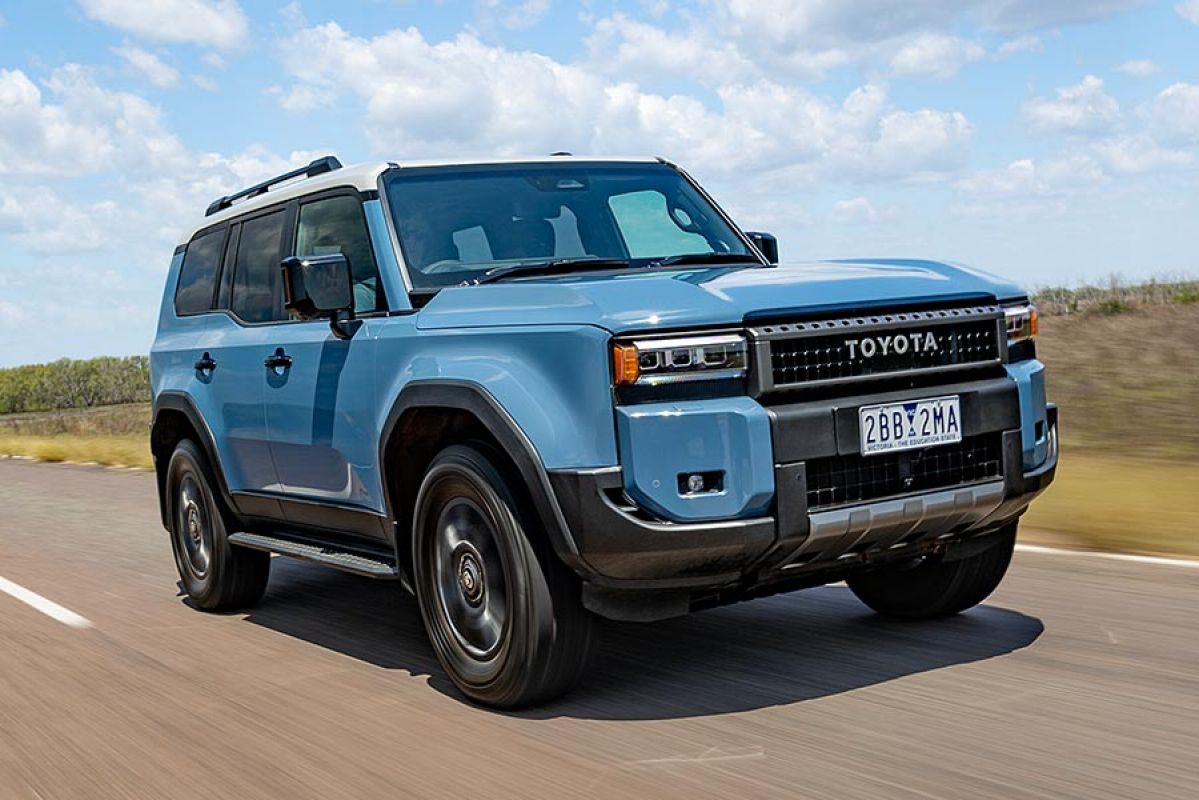 Blue Toyota Prado Altitude SUV on wide, open country road
