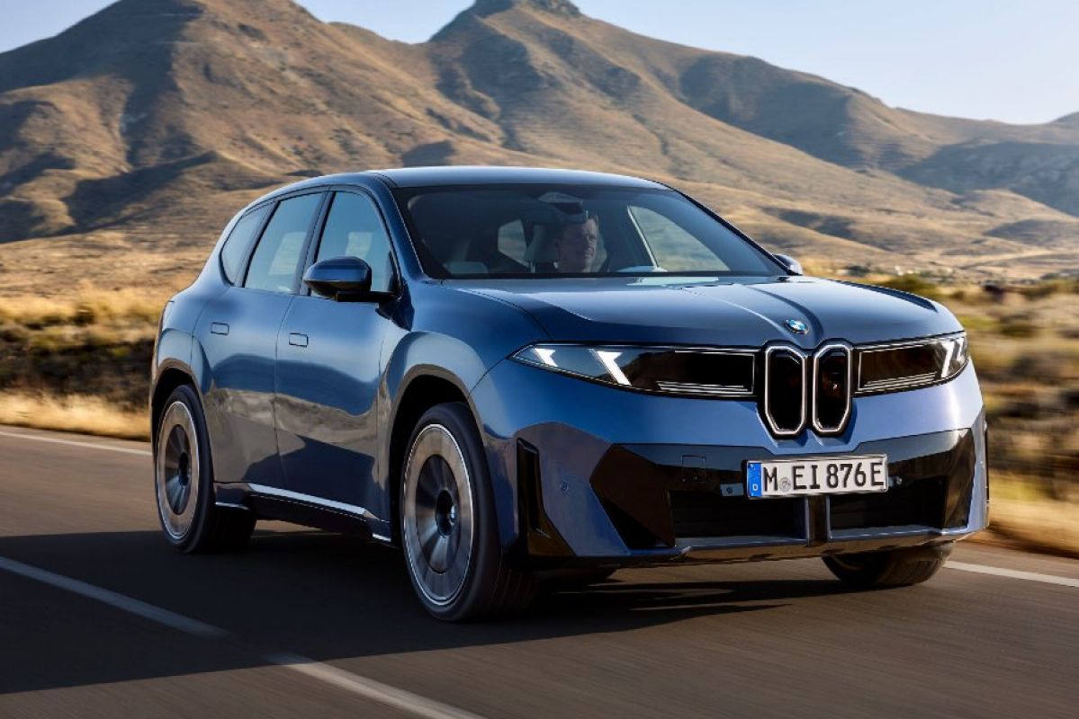 blue 2026 BMW iX3 driving on road