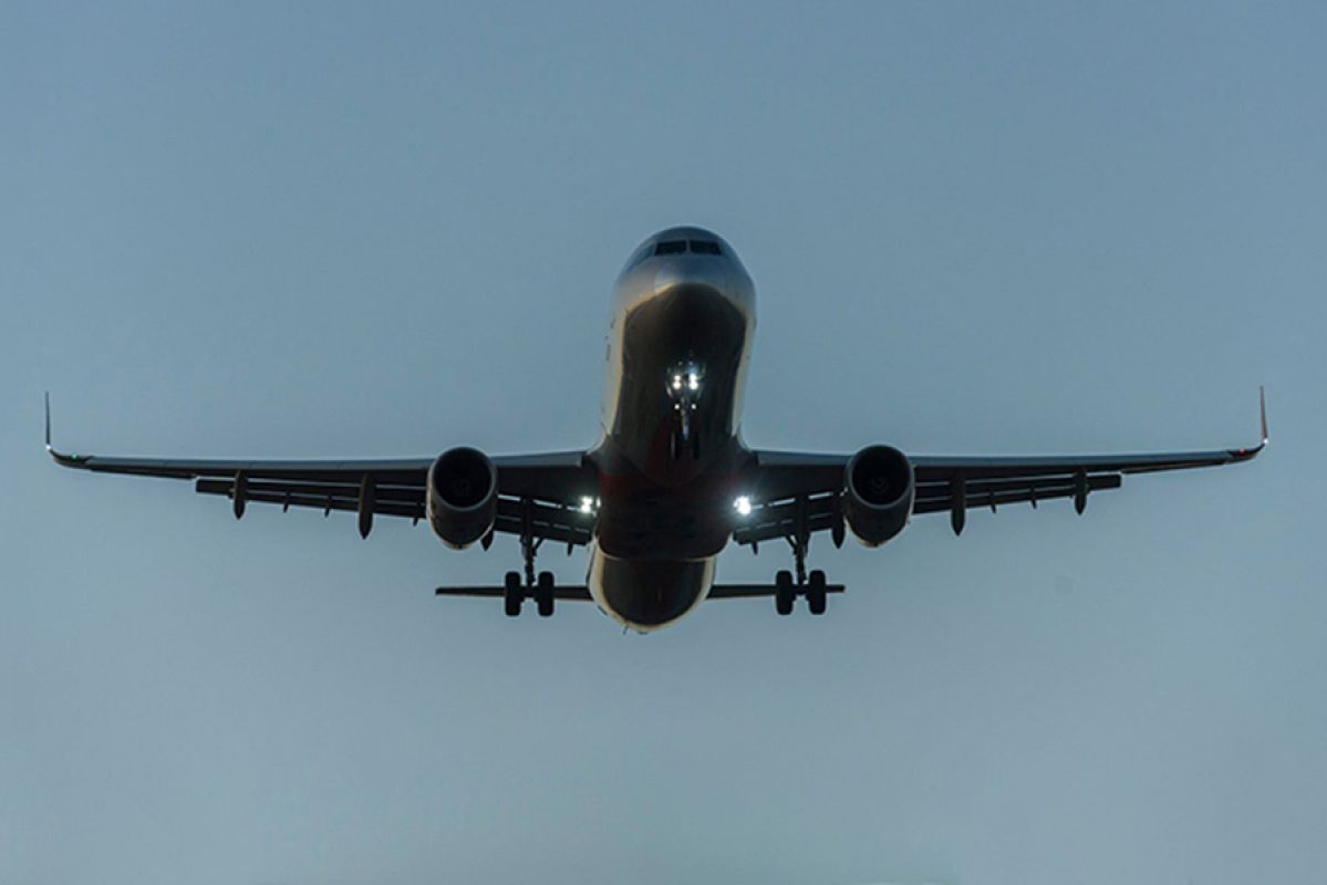 Plane flying above airport