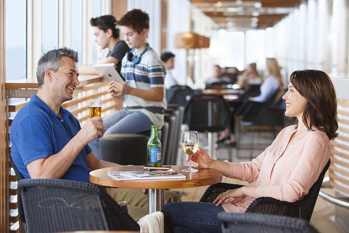 Four people in a blue convertible waiting to board the Spirit of Tasmania ship