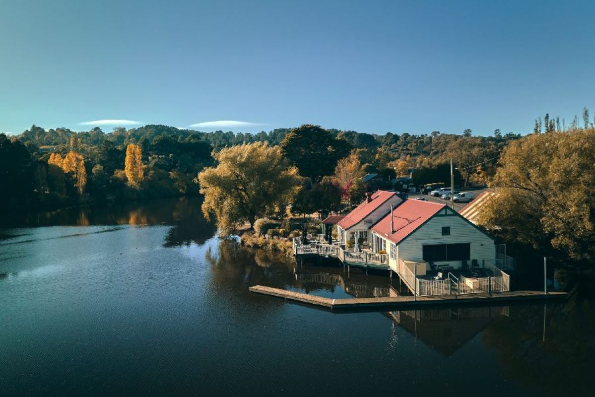 aerial shot of large lake and boathouse
