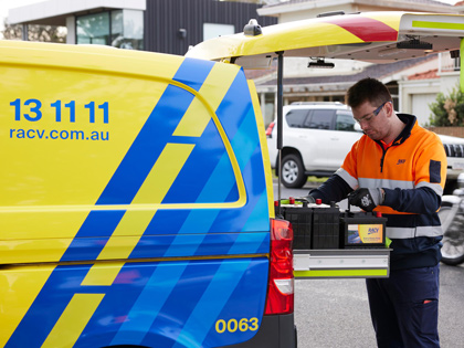 RACV partolman getting a battery out of the van.