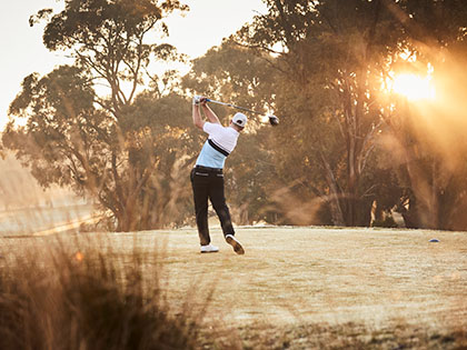 Man playing golf on fields at RACV Goldfields Resort near Ballarat.