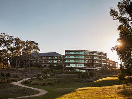 Exterior view of RACV Goldfields resort at golden hour.