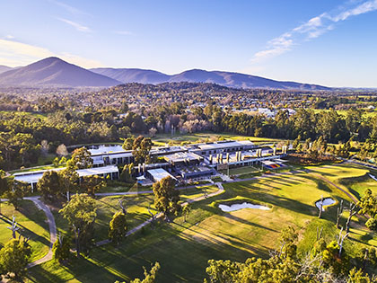 Aerial view of RACV Country Club and surrounding mountains.