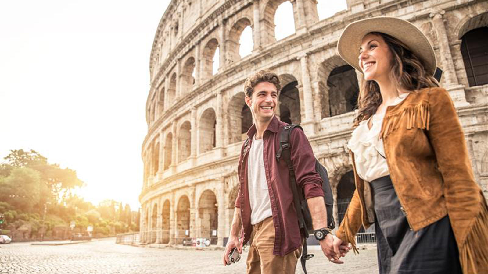 Couple holding hands at the Colosseum.
