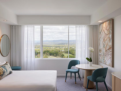 Deluxe Mountain View Room, at RACV Royal Pines, featuring queen bed and seating area.