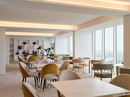 Executive Lounge at RACV Royal Pines Resort, featuring tables and chairs, and a view overlooking the resort and surrounding area.