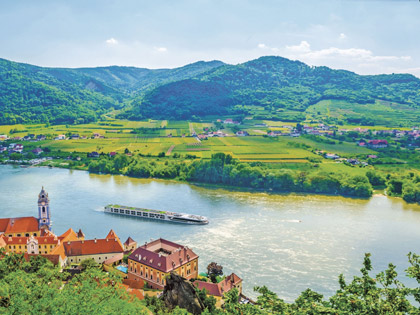 A cruise ship with rolling hills in the background. 